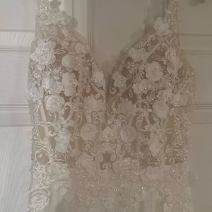 White prom dress with lace and embroidered bodice and gathered at the butt.